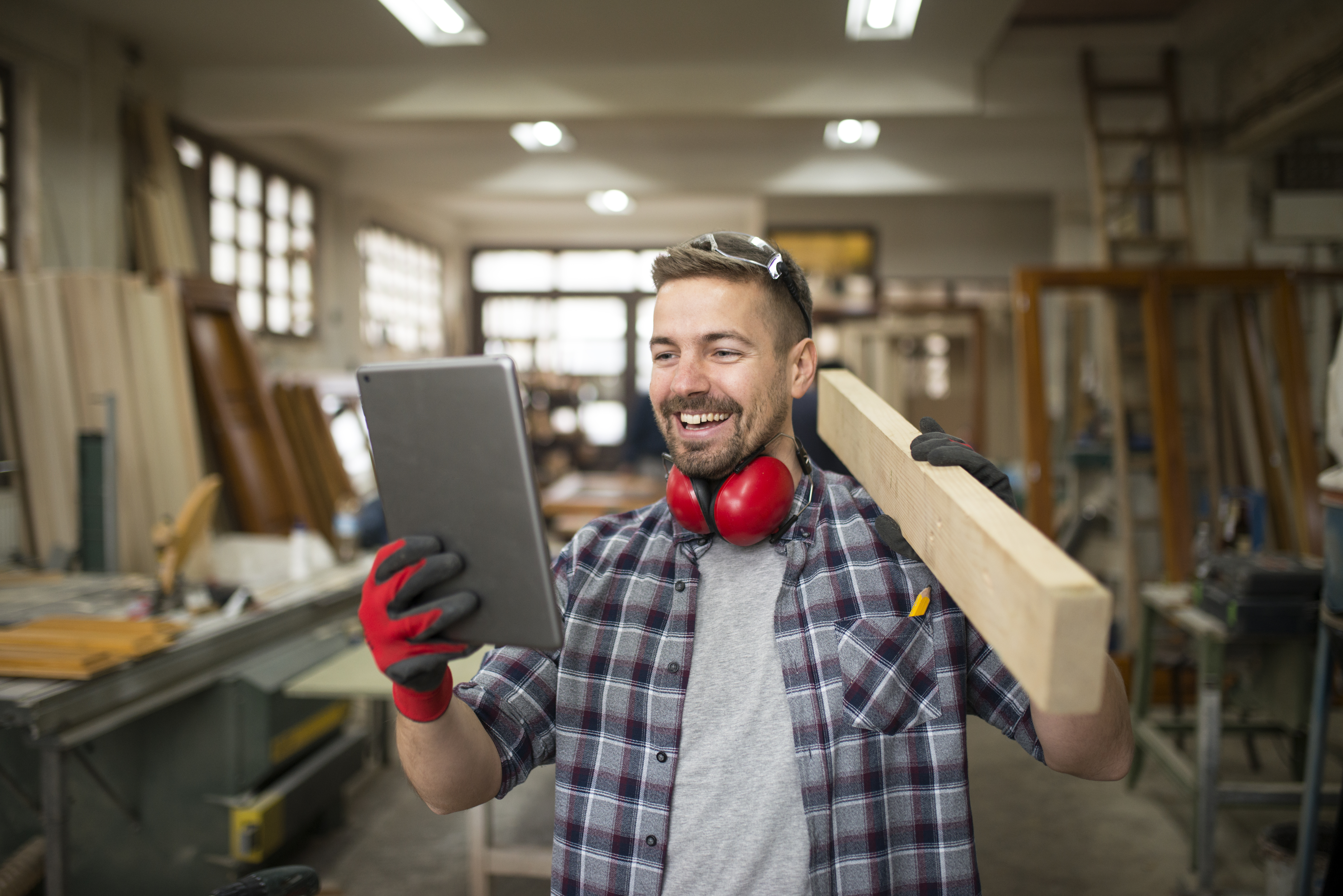 young-professional-carpenter-holding-wood-material-looking-tablet-carpentry-workshop.jpg